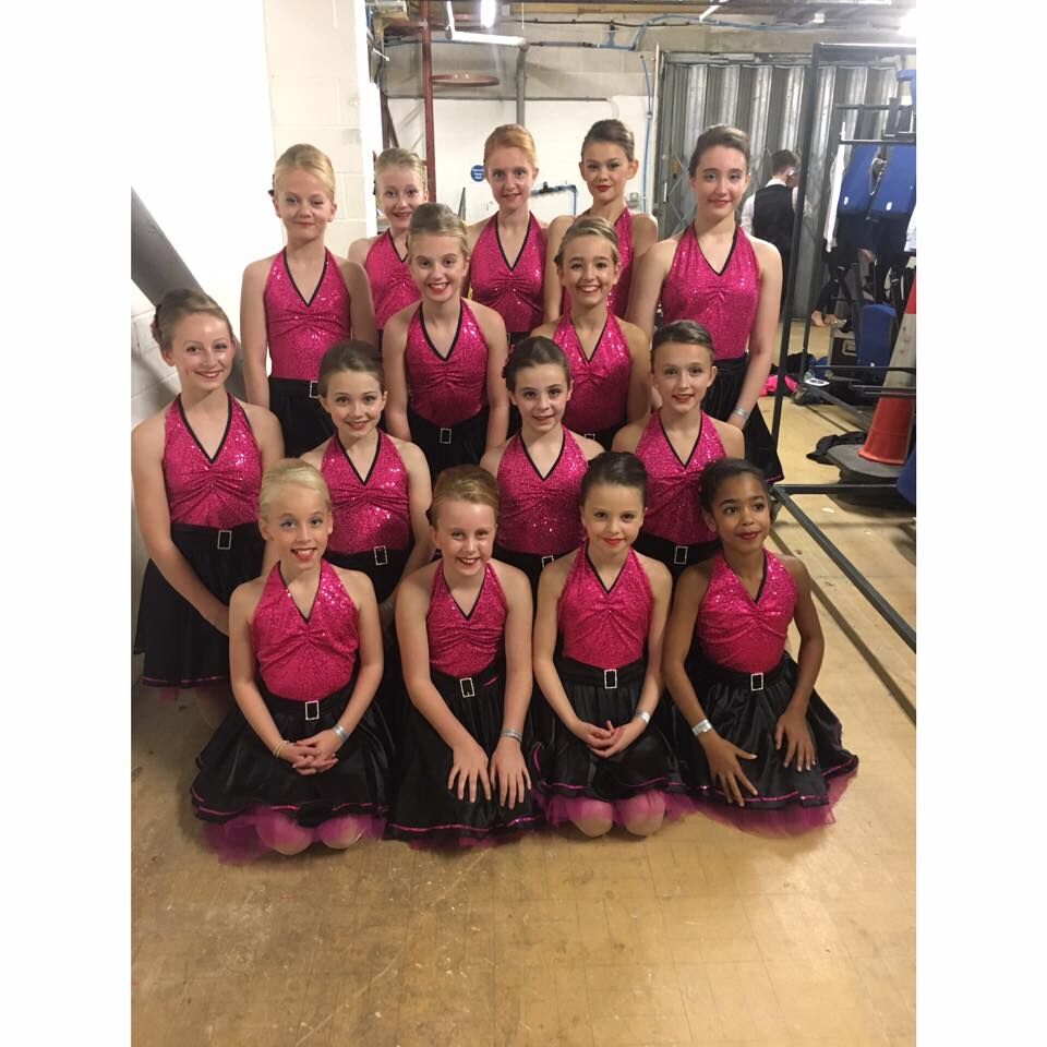 group of girl dancers dressed in pink and black